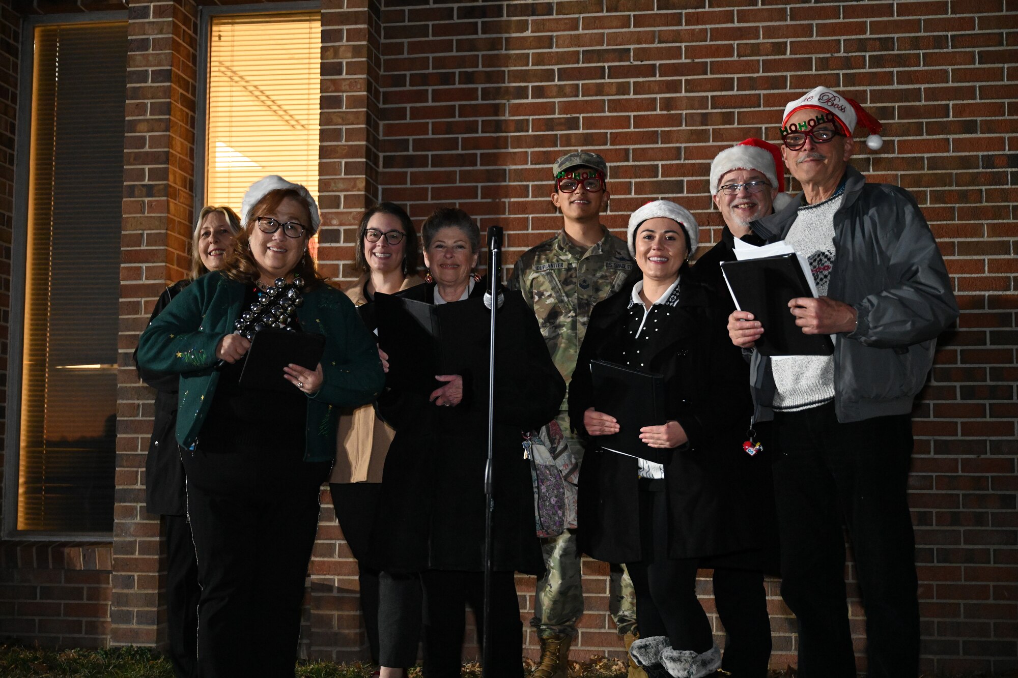 The group stands together preparing to sing