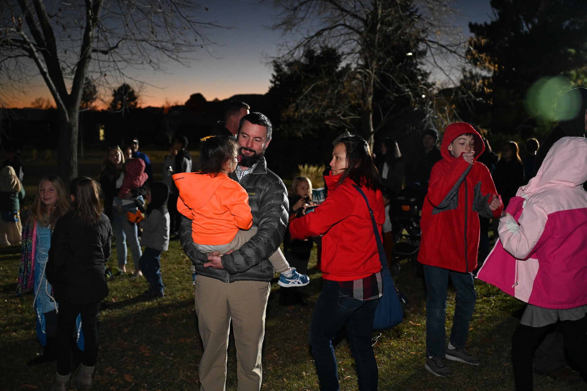 A father holds his daughter amongst the crowd gathered to for the tree lighting event.