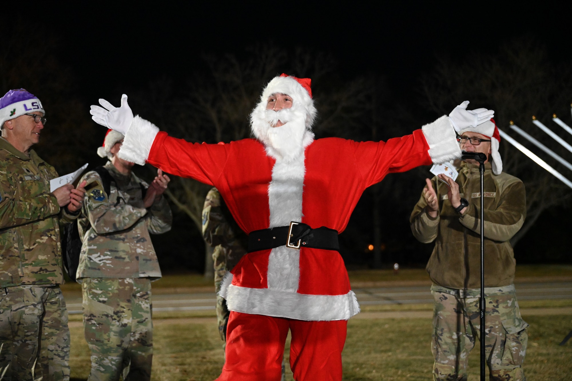 Santa Claus stands in front of a microphone after he gave a speech.