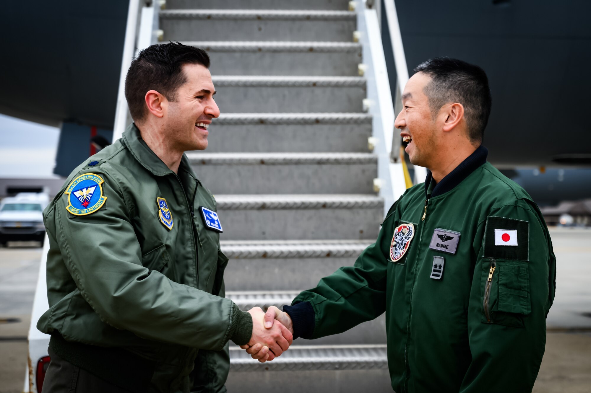 U.S. Air Force Lt. Col. Paul Lasorda, 32nd Air Refueling Squadron commander, greets Japan Air Self-Defense Force Lt. Col. Namme Akihiro, 3rd Tactical Airlift Wing commander, at Joint Base McGuire-Dix-Lakehurst, N.J., Dec. 9, 2024. The JASDF visit involved a subject matter expert exchange designed to enhance interoperability with U.S. Air Force KC-46A aircraft units. (U.S. Air Force photo by Senior Airman Matt Porter)