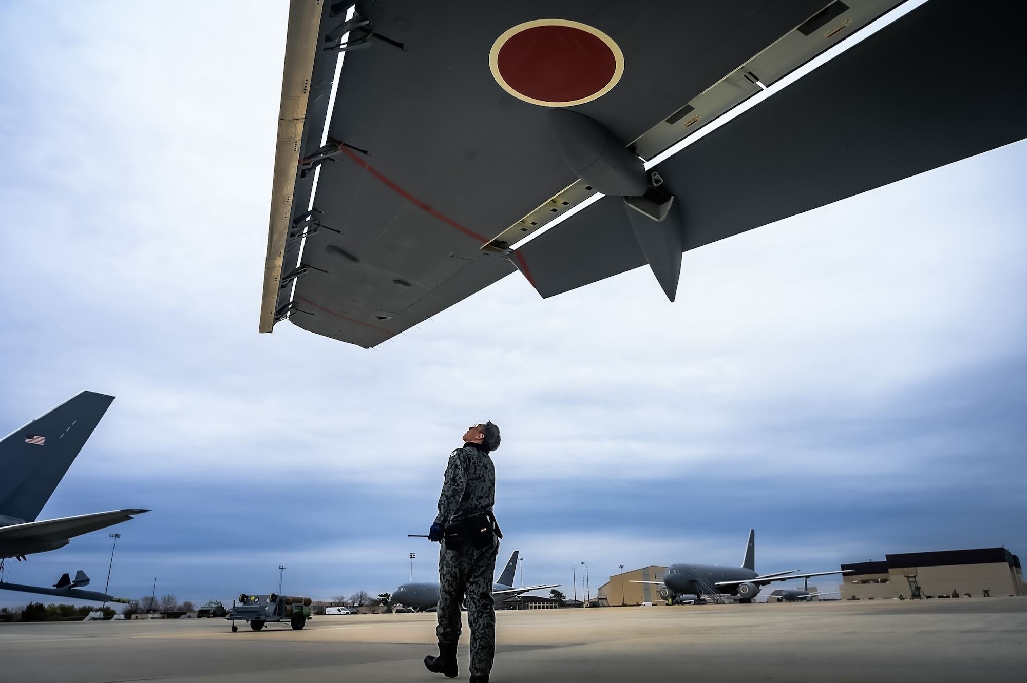 Japan Air Self-Defense Force Senior Airman Yuya Kaneda, 3rd Tactical Airlift Wing aircraft maintainer, performs a maintenance inspection on a KC-46A aircraft at Joint Base McGuire-Dix-Lakehurst, N.J., Dec. 9, 2024. The JASDF visit involved a subject matter expert exchange designed to enhance interoperability with U.S. Air Force KC-46A aircraft units. (U.S. Air Force photo by Senior Airman Matt Porter)
