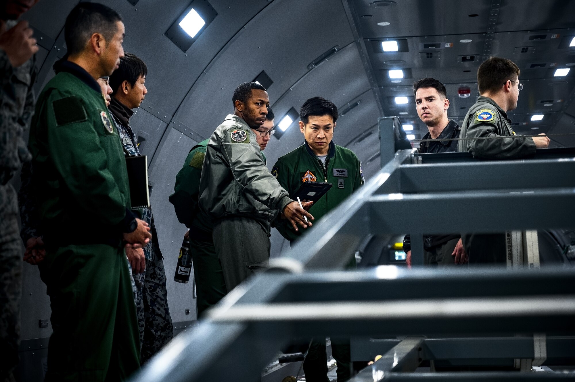 U.S. Air Force Staff Sgt. Charles Moore, 32nd Air Refueling Squadron boom operator, instructs Japan Air Self-Defense Force Airmen assigned to the 3rd Tactical Airlift Wing on a KC-46A aircraft at Joint Base McGuire-Dix-Lakehurst, N.J., Dec. 10, 2024. The JASDF visit involved a subject matter expert exchange designed to enhance interoperability with U.S. Air Force KC-46A aircraft units. (U.S. Air Force photo by Senior Airman Matt Porter)