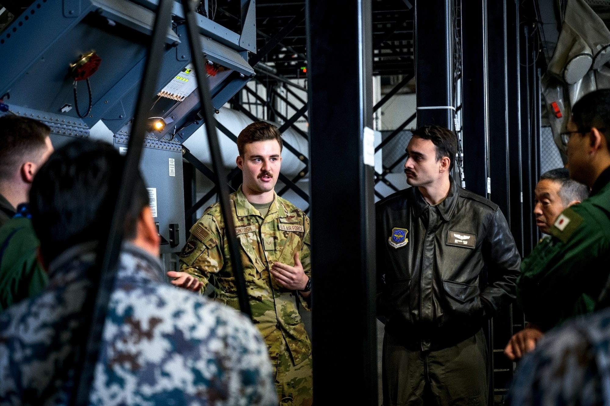 U.S. Air Force Senior Airman Elliott McIntosh, 32nd Air Refueling Squadron boom operator, instructs Japan Air Self-Defense Force Airmen assigned to the 3rd Tactical Airlift Wing at Joint Base McGuire-Dix-Lakehurst, N.J., Dec. 10, 2024. The JASDF visit involved a subject matter expert exchange designed to enhance interoperability with U.S. Air Force KC-46A aircraft units. (U.S. Air Force photo by Senior Airman Matt Porter)