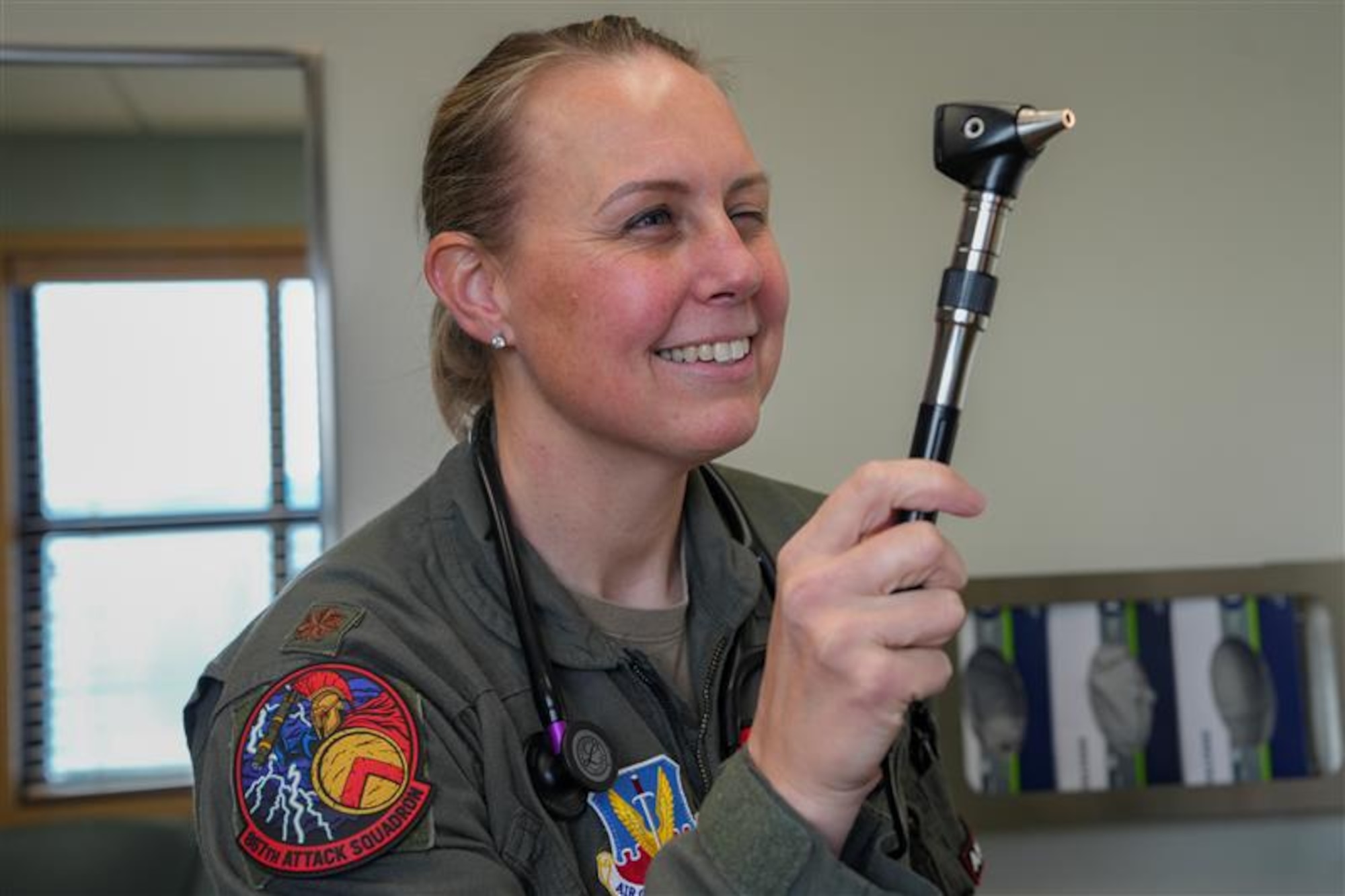 An airman examines a patient during a check-up.
