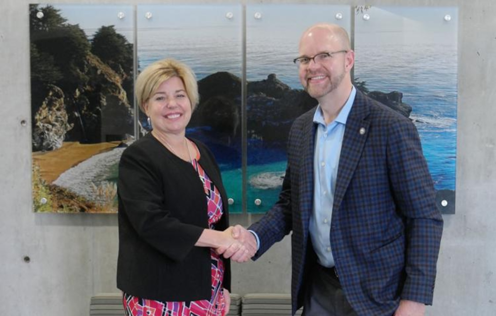 DSCA Director Heidi Grant shakes hands with ISG personnel