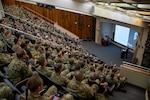 Auditorium full of uniformed service members.