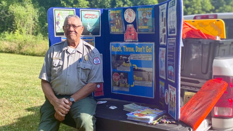 Dale Hollow Lake Park Ranger Bobby Bartlett poses with a water safety exhibit Oct. 29, 2024, before sharing information at the Kids Fishing Rodeo at the Dale Hollow Lake National Fish Hatchery June 10, 2023 in Celina, Tennessee. The U.S. Army Corps of Engineers Nashville District is proud of his service to the lake and community for the past half century. He began working for the Corps of Engineers in 1985 and has since held multiple positions as a park host, maintenance worker, park technician, and park ranger. (USACE Photo by Desmaray Brown)