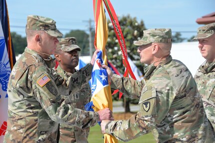 Gen. Ed Daly passes the U.S. Army Security Assistance Command flag to Brig. Gen. Garrick Harmon