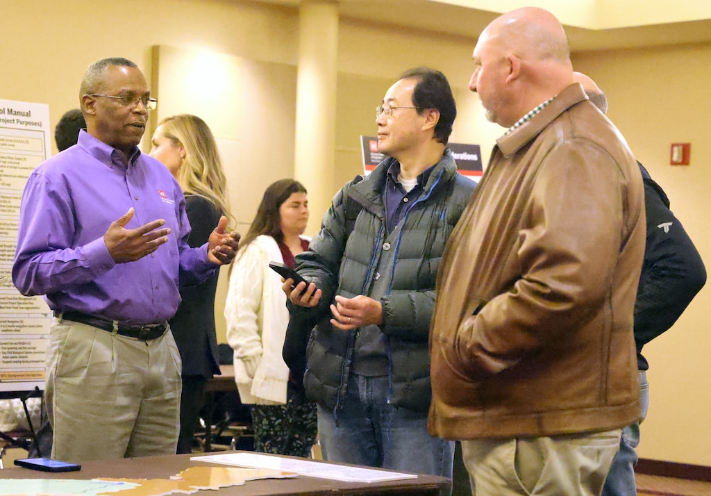 Men talking at a conference.