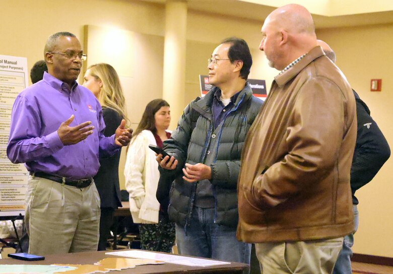 Men talking at a conference.