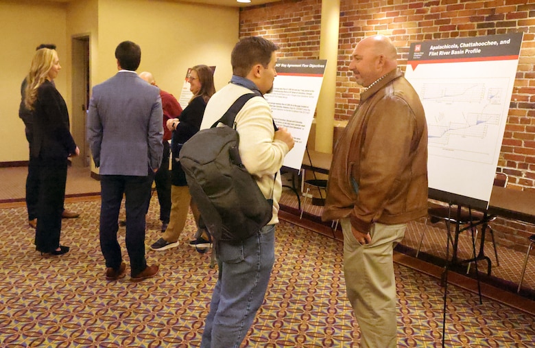 Two men talking at a conference.
