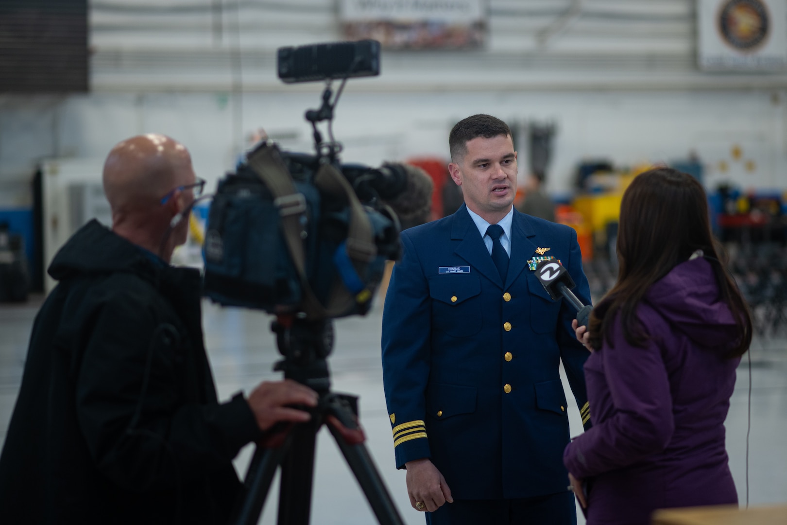 Lt. Cmdr. Jacob Conrad speaks to news media on his experience during a search and rescue case conducted, Dec. 29, 2023, at Coast Guard Air Station San Francisco, Dec. 12, 2024. During the case, Conrad and his aircrew rescued two stranded individuals and assisted two local rescuers. (U.S. Coast Guard photo by Petty Officer 3rd Class Hunter Schnabel)