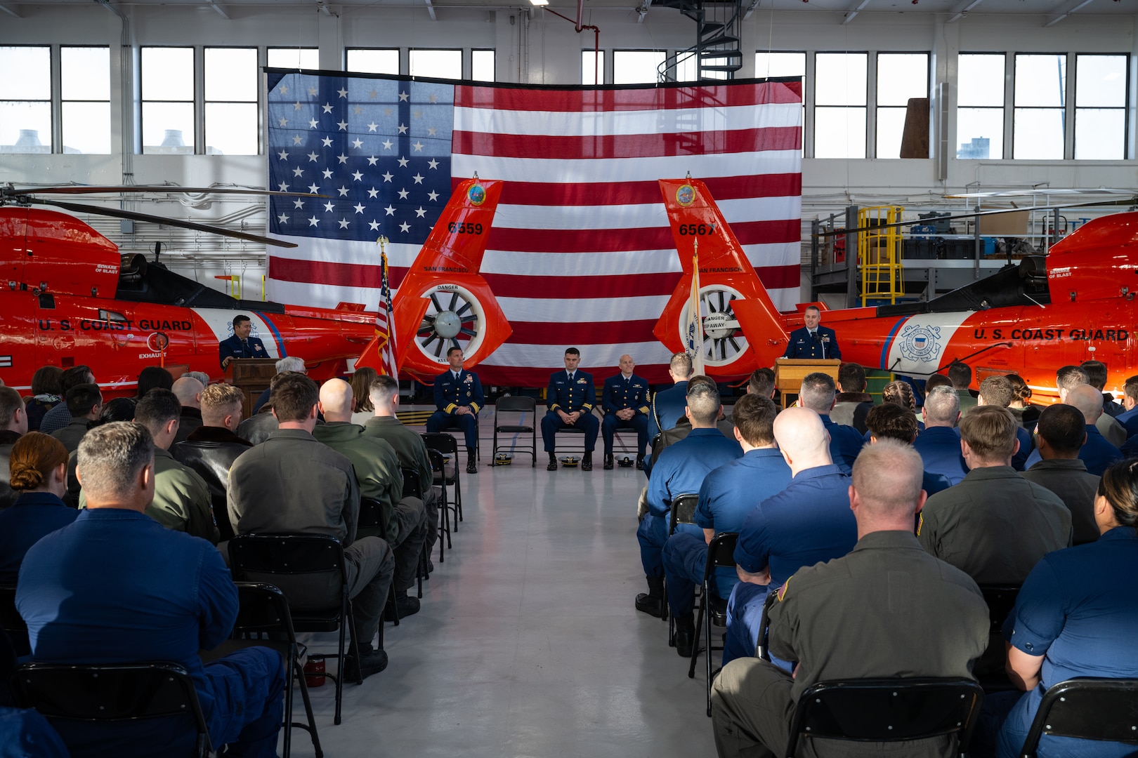 Service members participate in an award ceremony at Air Station San Francisco, Dec. 12, 2024. During the ceremony, Lt. Cmdr. Jacob Conrad was awarded the Distinguished Flying Cross Medal for his actions during a search and rescue case on Dec. 29, 2023. (U.S. Coast Guard photo by Petty Officer 3rd Class Hunter Schnabel)