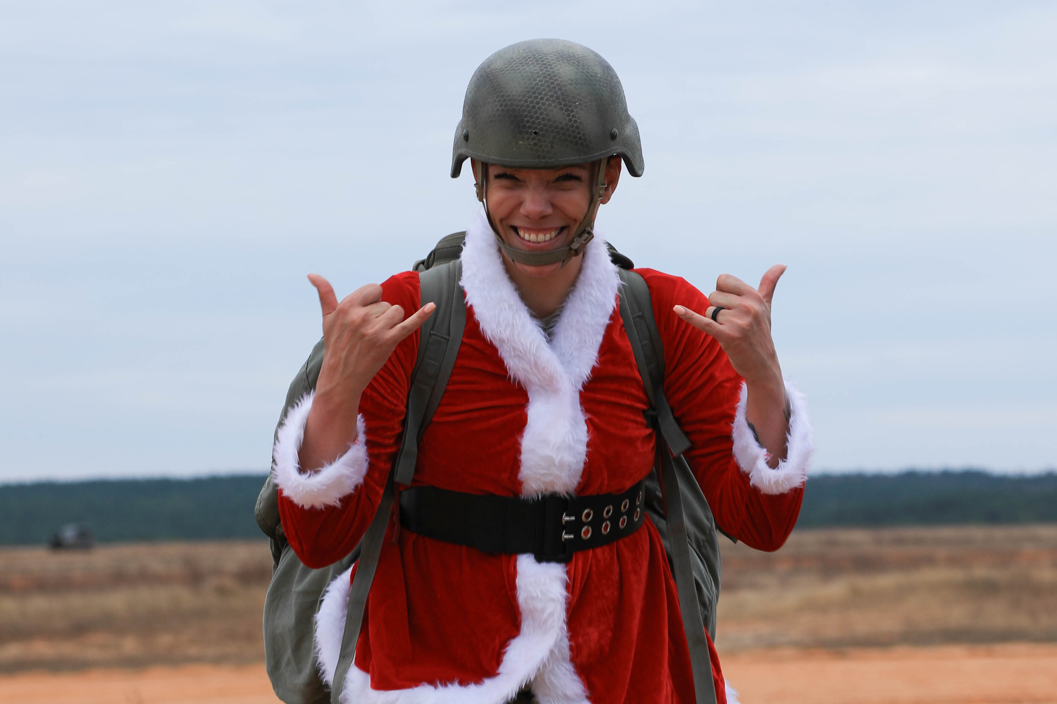 An Army paratrooper celebrates after a successful landing during the Randy Oler Memorial Toy Drop at Fort Liberty, N.C., Dec. 10, 2024.