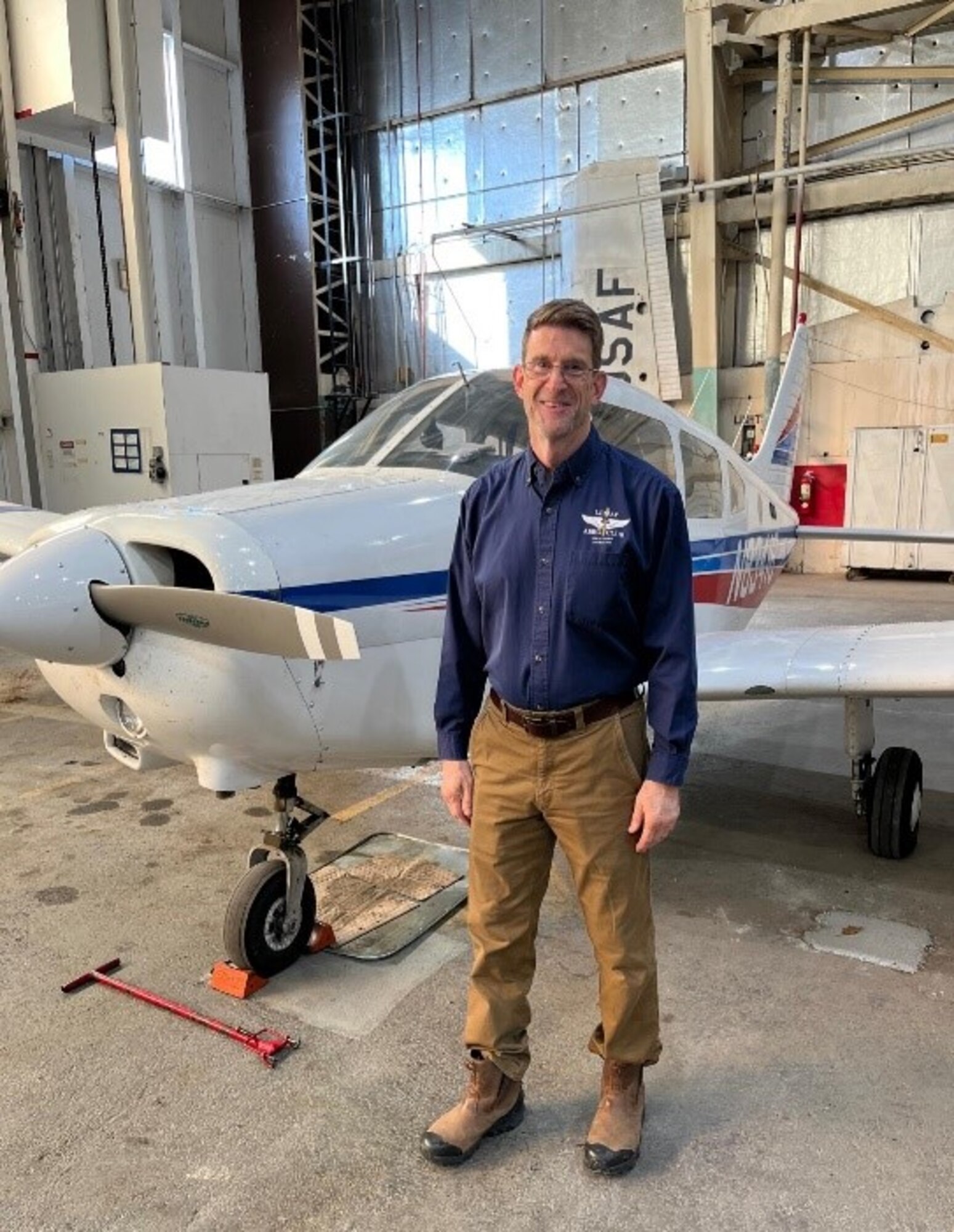 man standing in front of plane
