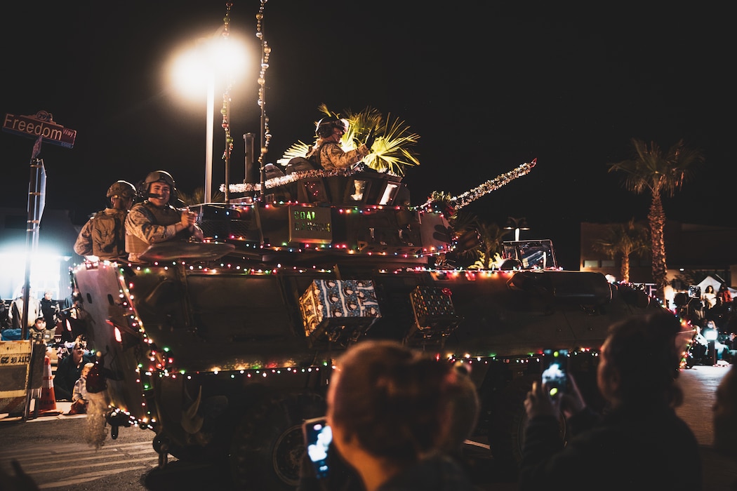U.S. Marines with 3rd Light Armored Reconnaissance Battalion drive a light armored vehicle in the Holiday Light Parade