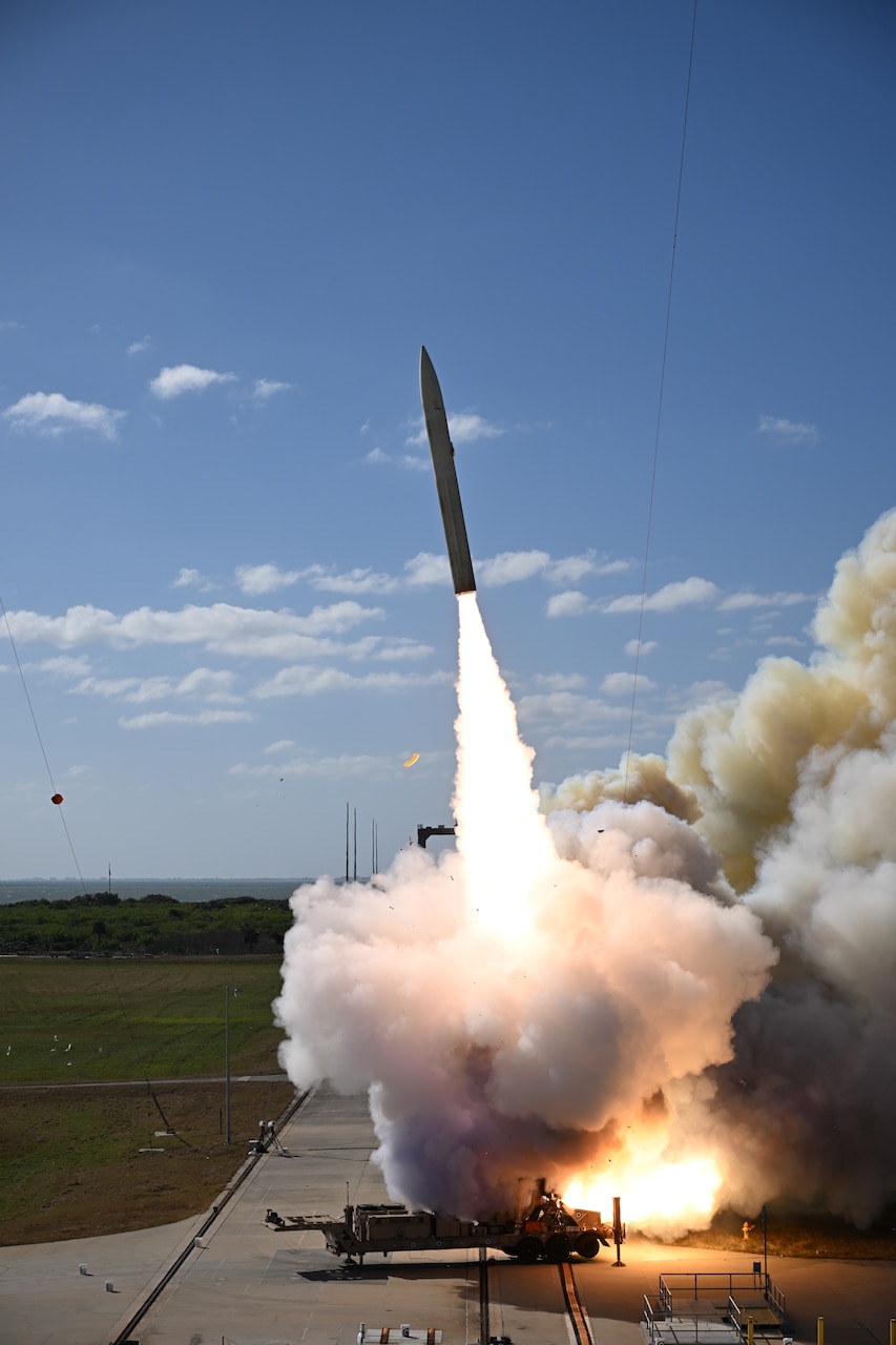 A missile launches leaving behind a trail of smoke.