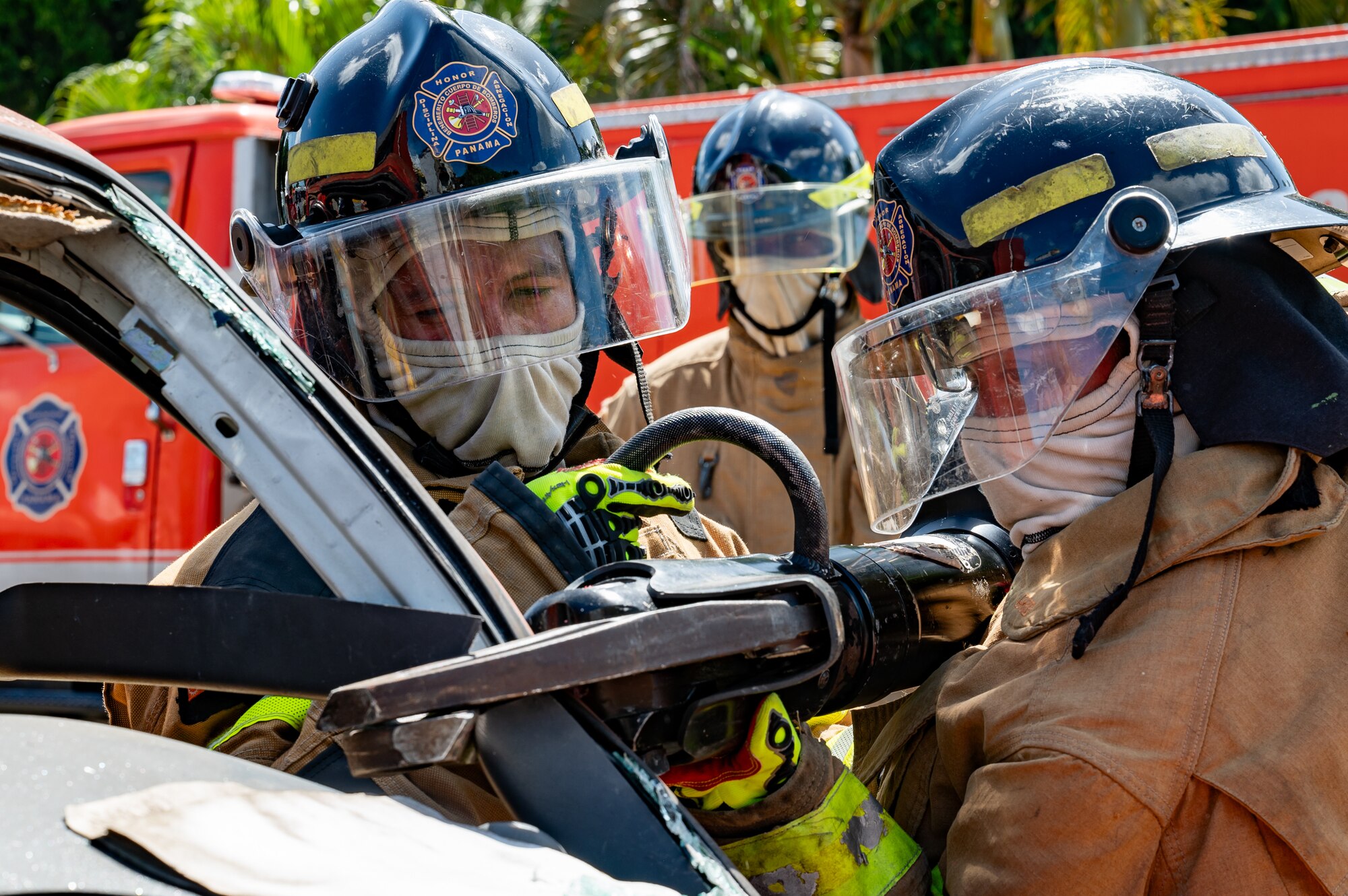 Panama firefighters cut a car door during a training exercise in Chepo, Panama, Dec. 12, 2024.