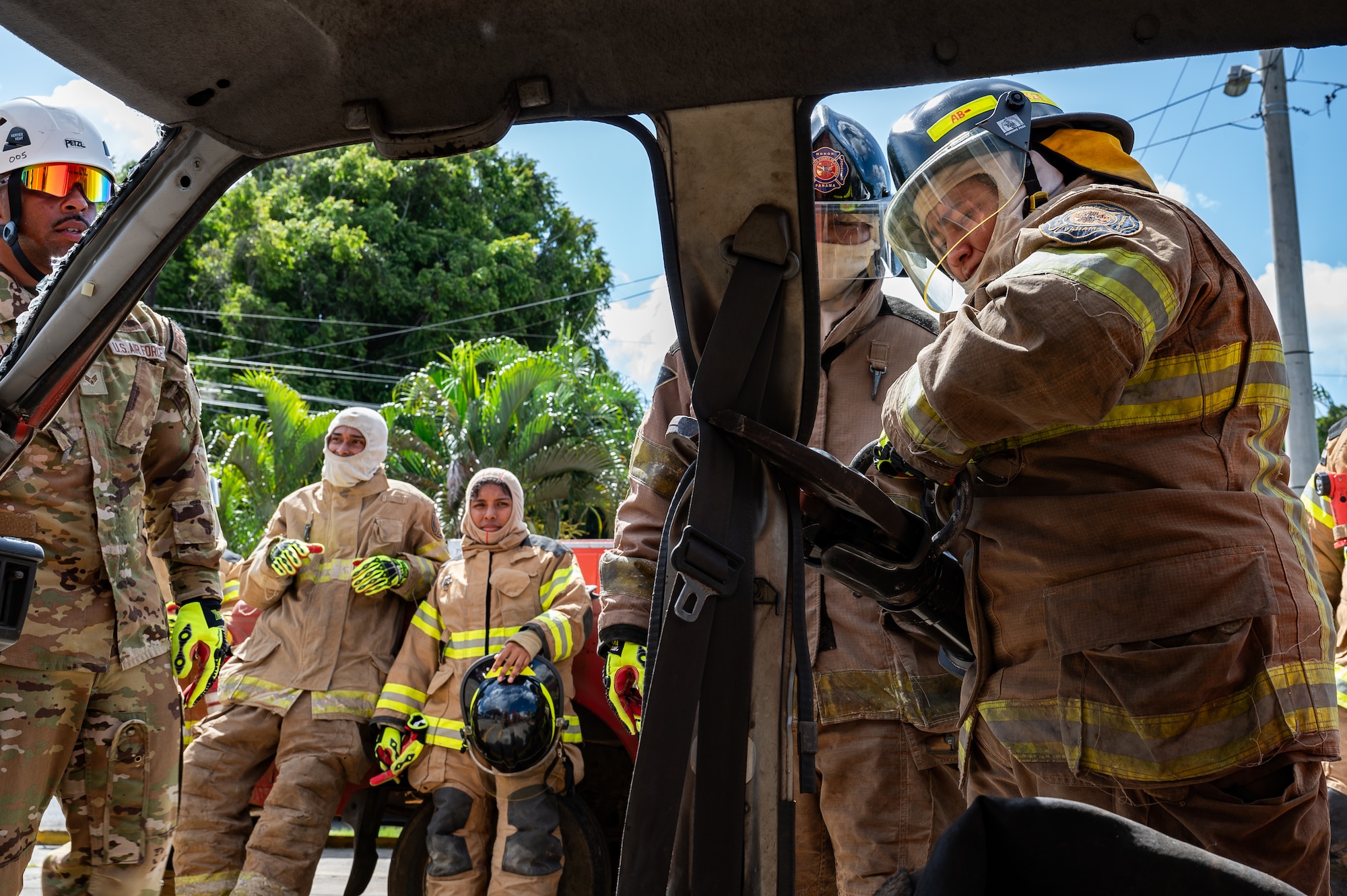 A Panama firefighter cuts a car door during a training exercise in Chepo, Panama, Dec. 12, 2024.