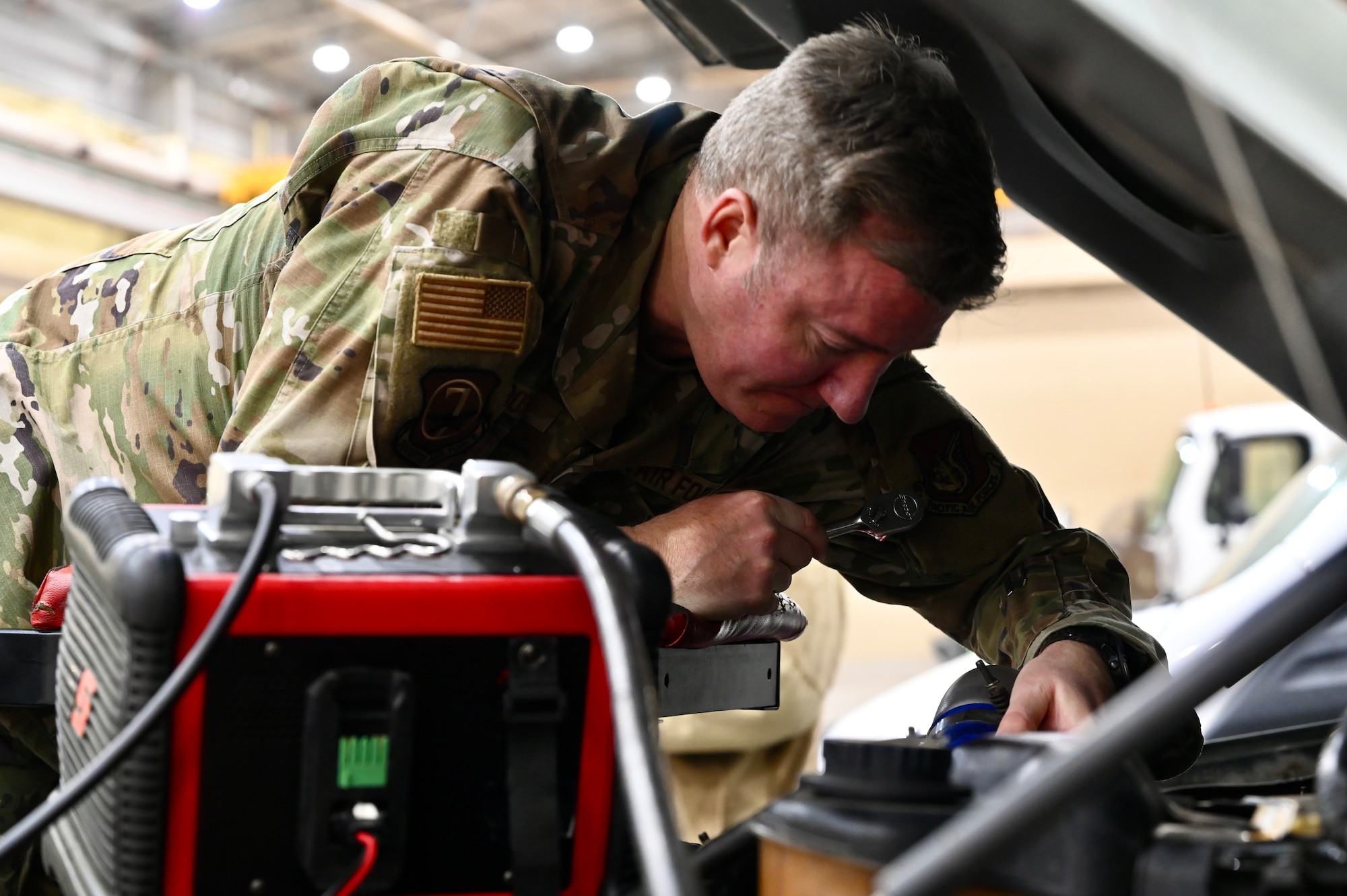 U.S. Air Force Chief Master Sgt. Jeremiah W. Ross, Seventh Air Force command chief, performs an engine check on a government vehicle during a tour of the 8th Logistics Readiness Squadron at Kunsan Air Base, Republic of Korea.