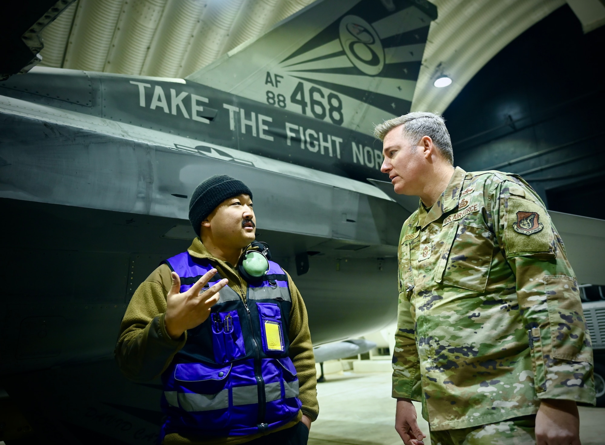 U.S. Air Force Tech. Sgt. Joshua An, Cobra Fighter Generation Squadron dedicated crew chief, briefs Chief Master Sgt. Jeremiah W. Ross, Seventh Air Force command chief, during a tour of the 8th Logistics Readiness Squadron at Kunsan Air Base, Republic of Korea.