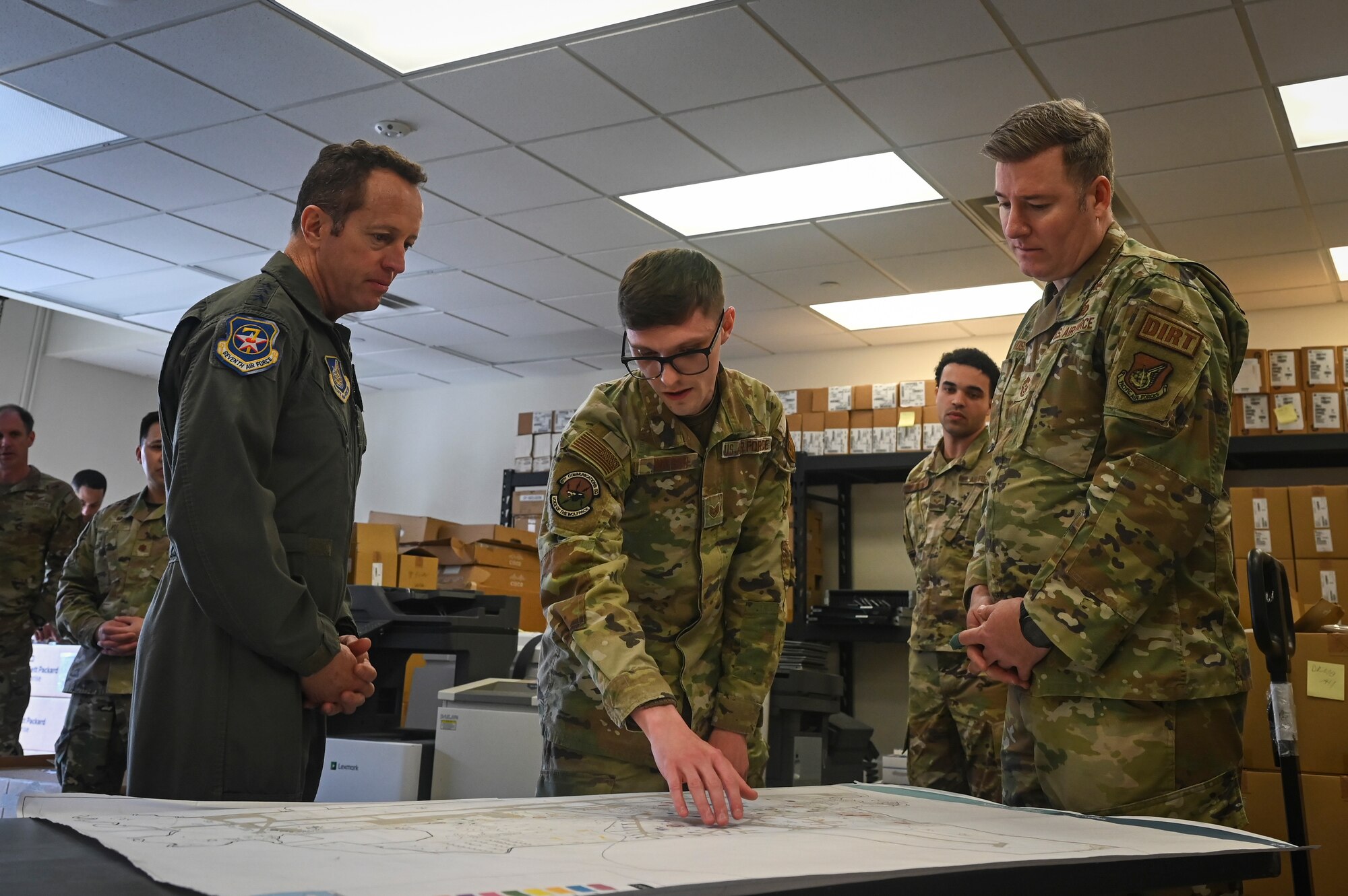 U.S. Air Force Staff Sgt. Jeremy Watson, 8th Communication Squadron installation spectrum manager, briefs Lt. Gen. David R. Iverson, Seventh Air Force commander, and Chief Master Sgt. Jeremiah W. Ross, Seventh Air Force command chief, during a tour at Kunsan Air Base, Republic of Korea.
