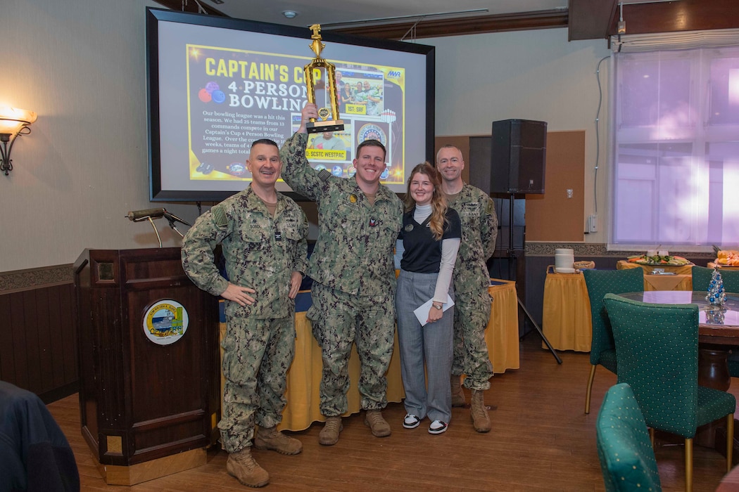 Capt. Les Sobol, Commander, Fleet Activities Yokosuka (CFAY), awards 2024 CFAY Captain's Cup winners in the installation's Kurofune Lounge at the Officers' Club.