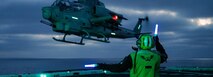 U.S. Navy Aviation Boatswain's Mate (Handling) 1st Class Reyvin Olaes, a native of Cavite, Philippines, signals to a U.S. Marine Corps AH-1Z Viper assigned to Marine Light Attack Helicopter Squadron (HMLA) 169, Marine Aircraft Group 39, 3rd Marine Aircraft Wing, as it takes off from the flight deck of amphibious transport dock ship USS Somerset (LPD 25) during Steel Knight 24 while underway in the Pacific Ocean, Dec. 8, 2024.