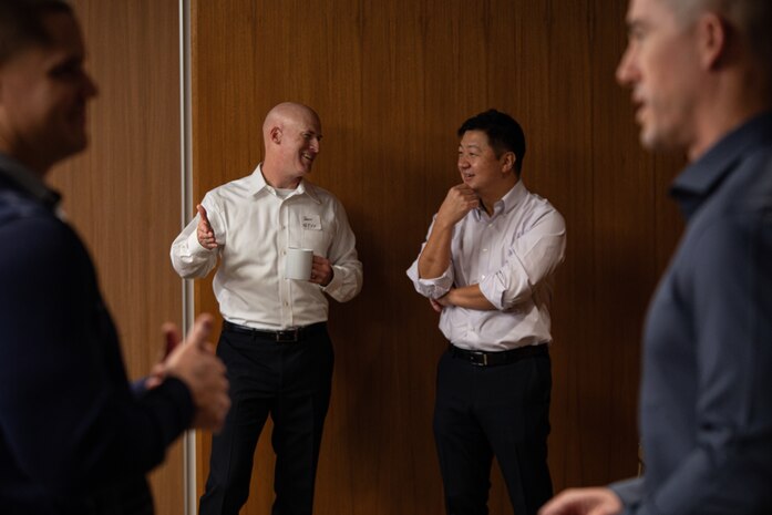U.S. Marine Corps Col. Jason Berg, commanding officer of Combat Logistics Battalion 3, 3rd Marine Logistics Group, left, has a discussion with KUROISHI Ryo, the general affairs section officer of the Okinawa Liaison Office, Ministry of Foreign Affairs (MOFA), during a senior leadership symposium at Kadena Air Base, Okinawa, Japan, Dec. 4, 2024. The event provided senior leadership within CLR-3 an opportunity for open discussions while fostering collaboration and mutual understanding with our Japanese counterparts. Guest speakers included representatives from the Okinawa Defense Bureau, MOFA, Japan Ground Self-Defense Force, and the commanding general of 3rd MLG. (U.S. Marine Corps photo by Lance Cpl. Rachel Mason)