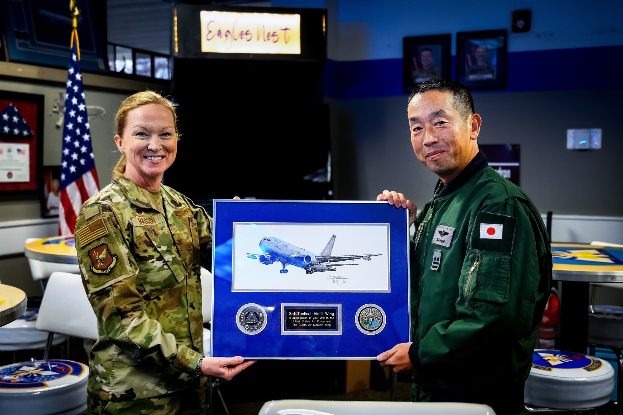 U.S. Air Force Col. Kathleen Hasson, 305th Air Mobility Wing commander, and Japan Air Self-Defense Force Lt. Col. Namme Akihiro, 3rd Tactical Airlift Wing commander, pose for a photo at Joint Base McGuire-Dix-Lakehurst, N.J., Dec. 10, 2024. The JASDF visit involved a subject matter expert exchange designed to enhance interoperability with U.S. Air Force KC-46A aircraft units. (U.S. Air Force photo by Senior Airman Matt Porter)