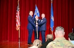 Col. Douglas C. Jeffrey IV, 433rd Airlift Wing commander, presents the guidon to Lt. Col. Jeremy A. Patrick, 433rd Operations Group commander, during the 433rd OG assumption of command ceremony at Joint Base San Antonio-Lackland, Texas, Dec. 7, 2024.