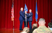 Col. Douglas C. Jeffrey IV, 433rd Airlift Wing commander, presents the guidon to Lt. Col. Jeremy A. Patrick, 433rd Operations Group commander, during the 433rd OG assumption of command ceremony at Joint Base San Antonio-Lackland, Texas, Dec. 7, 2024.