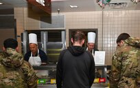 Honorary Commander Dave Bonney, First Command financial advisor, and Col. Douglas C. Jeffrey IV, 433rd Airlift Wing Commander, prepare plates of food for service members during the “Feed the Troops” event at the Live Oak Dining Facility on Joint Base San Antonio-Lackland, Texas, Dec. 7, 2024.