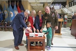 eft to right, Defense Technical Information Center Administrator Christopher Thomas; Defense Threat Reduction Agency Director of Acquisition, Contracts and Logistics Directorate Teresa Kless; Defense Contract Audit Agency Deputy Director Debra Caw; and Defense Logistics Agency Director Army Lt. Gen. Mark Simerly, , light the holiday tree during a ceremony accompanied by two preschool students from the McNamara Headquarters Complex Child Development Center