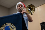 U.S. Air Force Senior Airman Jeff Sharoff, regional band trombone for the U.S. Air Force Band of the Pacific-Asia, Pacific Brass Quintet, plays his instrument at Okkodo High School, Dededo, Guam, Dec. 10, 2024. The Pacific Brass Quintet visited schools in Guam, Saipan and Tinian during the 73rd Operation Christmas Drop exercise on Andersen Air Force Base. (U.S. Air Force photo by Airman 1st Class Natasha Ninete)