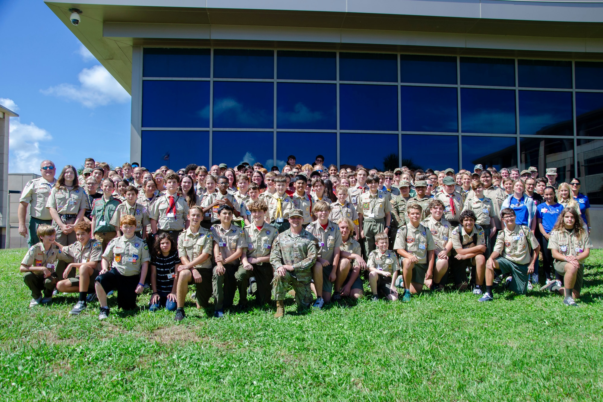 More than 100 scouts, trailblazers, troop leaders, advisors, and parents pose for a group photo with volunteers from the Air Force Technical Applications Center during the center’s annual Nuclear Science Merit Badge event. (U.S. Air Force photo by Susan A. Romano)