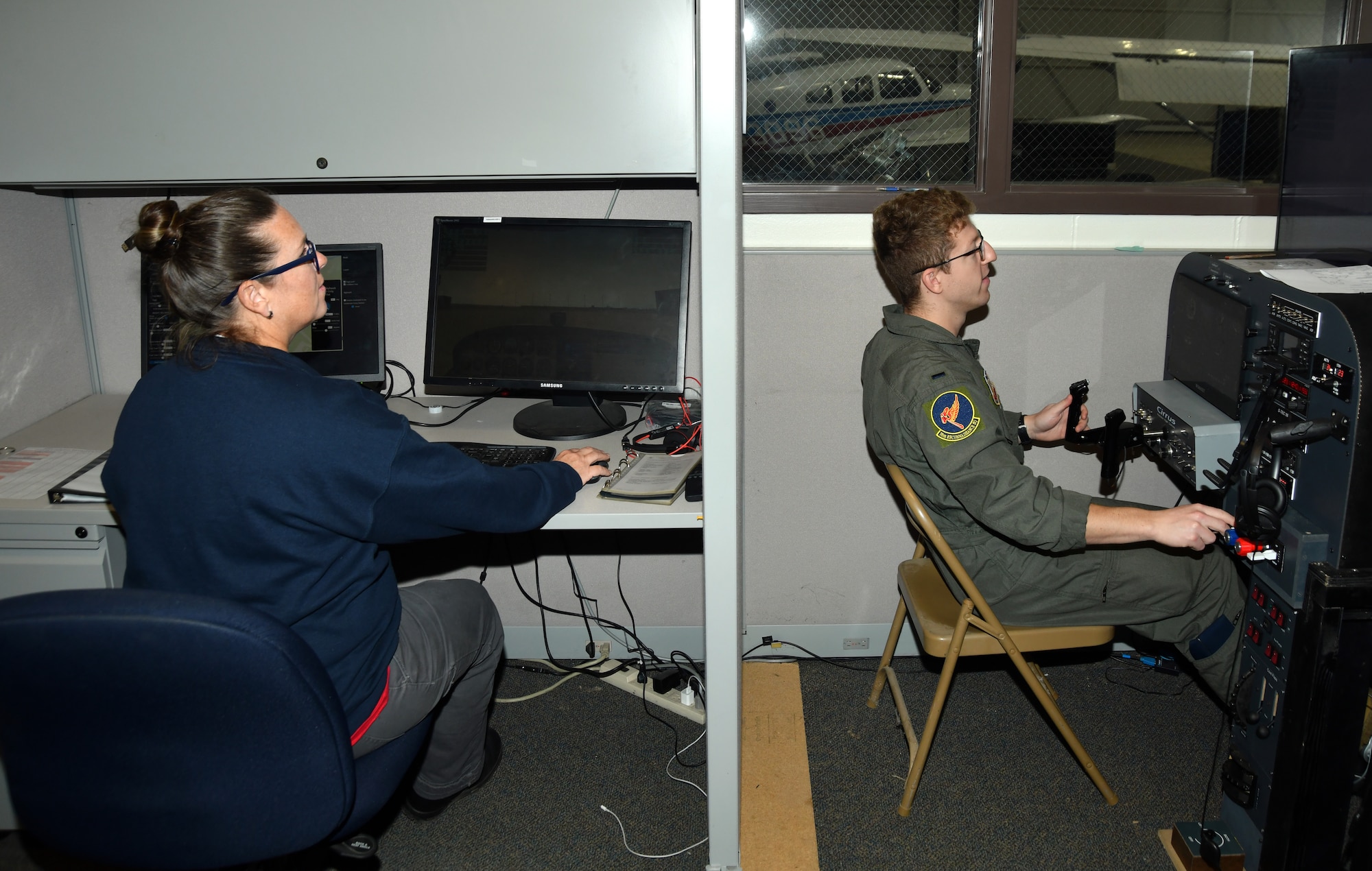 woman and man using flight simulators