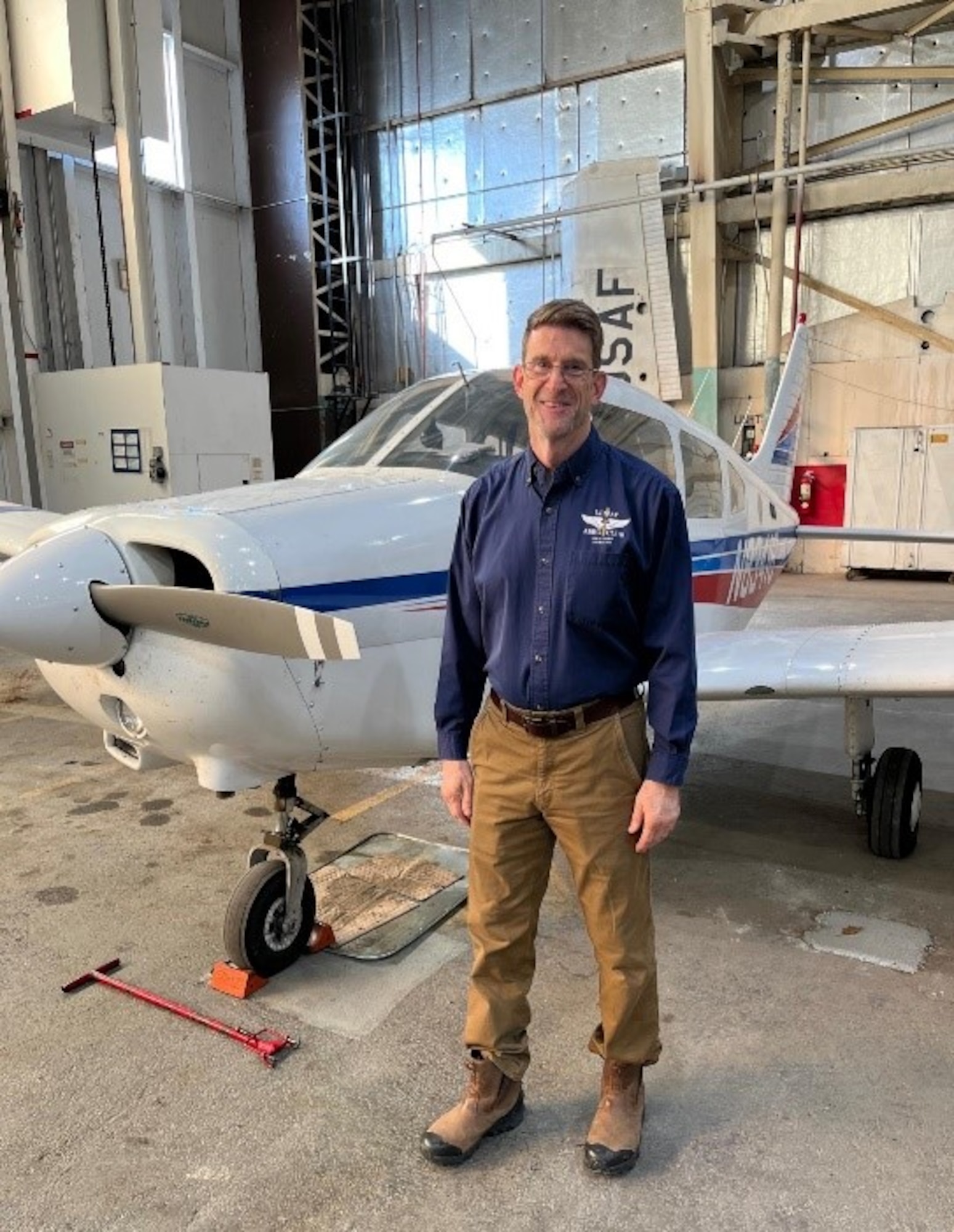 man standing in front of plane