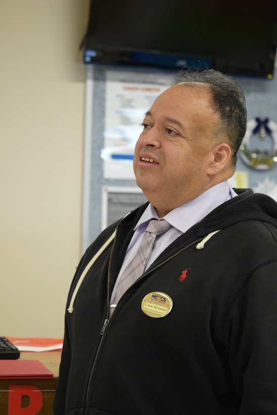 Ceasar Hernandez, the Camp Fuji Marine Corps Community Services, Marine and Family Program specialist at Combined Arms Training Center, Camp Fuji, chats with others, after being awarded a Civilian Service Commendation medal, December 11, 2024.  (U.S. Marine Corps photo by Song Jordan)