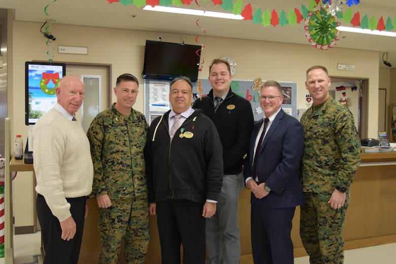 (Left to Right) Ed Hutsell, Col. Scott D. Welborn, Ceasar Hernandez, Matthew Schipper, Ed Cutshall, and Sgt. Maj. Christopher Gasser, pose for a group photo.