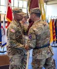 U.S. Army Europe and Africa Lt. Gen. Sean C. Bernabe, Deputy Commanding General (right) passes the unit flag to Col. Tracy Michael, commander, 68th Theater Medical Command (left) during the activation ceremony, Sep. 20, 2024 at Sembach, Germany. The role of the 68th Theater Medical Command is to coordinate, integrate, and synchronize medical support across the Europe and Africa theaters. (U.S. Army Photo by Elisabeth Paqué)