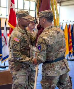 U.S. Army Europe and Africa Lt. Gen. Sean C. Bernabe, Deputy Commanding General (right) passes the unit flag to Col. Tracy Michael, commander, 68th Theater Medical Command (left) during the activation ceremony, Sep. 20, 2024 at Sembach, Germany. The role of the 68th Theater Medical Command is to coordinate, integrate, and synchronize medical support across the Europe and Africa theaters. (U.S. Army Photo by Elisabeth Paqué)