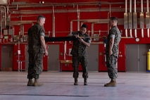 U.S. Marine Corps First Sgt. James Willet, company first sergeant, Combat Logistics Company-34, 3rd Marine Logistics Group, right, presents the company guidon to Brig. Gen. Kevin G. Collins, commanding general, 3rd MLG, left, and Maj. Inchul Ha, detachment commander, CLC-34, 3rd MLG, during CLC-34’s activation on Marine Corps Base Camp Blaz, Guam, Dec. 12, 2024. CLC-34’s basing in Guam represents a bolstered dispersal of logistics forces that support III MEF exercises and operations across the Indo-Pacific and are positioned to further enable cooperative security partnerships with regional partners and allies. The activation of CLC-34 marks another step in the planned laydown of Marine forces in the Indo-Pacific region aimed at being geographically distributed and operationally resilient, while maintaining readiness and capability during crises, disasters, or conflicts. (U.S. Marine Corps photo by Cpl. Brayden Daniel)