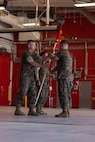 U.S. Marine Corps First Sgt. James Willet, company first sergeant, Combat Logistics Company-34, 3rd Marine Logistics Group, right, hands off the company guidon to Brig. Gen. Kevin G. Collins, commanding general, 3rd MLG, left, during CLC-34’s activation on Marine Corps Base Camp Blaz, Guam, Dec. 12, 2024. CLC-34’s basing in Guam represents a bolstered dispersal of logistics forces that support III MEF exercises and operations across the Indo-Pacific and are positioned to further enable cooperative security partnerships with regional partners and allies. The activation of CLC-34 marks another step in the planned laydown of Marine forces in the Indo-Pacific region aimed at being geographically distributed and operationally resilient, while maintaining readiness and capability during crises, disasters, or conflicts. (U.S. Marine Corps photo by Cpl. Brayden Daniel)