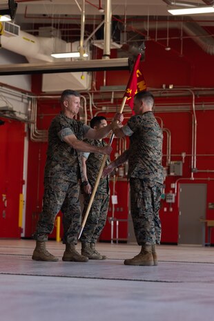 U.S. Marine Corps First Sgt. James Willet, company first sergeant, Combat Logistics Company-34, 3rd Marine Logistics Group, right, hands off the company guidon to Brig. Gen. Kevin G. Collins, commanding general, 3rd MLG, left, during CLC-34’s activation on Marine Corps Base Camp Blaz, Guam, Dec. 12, 2024. CLC-34’s basing in Guam represents a bolstered dispersal of logistics forces that support III MEF exercises and operations across the Indo-Pacific and are positioned to further enable cooperative security partnerships with regional partners and allies. The activation of CLC-34 marks another step in the planned laydown of Marine forces in the Indo-Pacific region aimed at being geographically distributed and operationally resilient, while maintaining readiness and capability during crises, disasters, or conflicts. (U.S. Marine Corps photo by Cpl. Brayden Daniel)