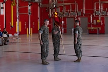 U.S. Marine Corps Maj. Inchul Ha, detachment commander, Combat Logistics Company-34, 3rd Marine Logistics Group, center, holds the company guidon after receiving it from Brig. Gen. Kevin G. Collins, commanding general, 3rd MLG, left, during CLC-34’s activation on Marine Corps Base Camp Blaz, Guam, Dec. 12, 2024. CLC-34’s basing in Guam represents a bolstered dispersal of logistics forces that support III MEF exercises and operations across the Indo-Pacific and are positioned to further enable cooperative security partnerships with regional partners and allies. The activation of CLC-34 marks another step in the planned laydown of Marine forces in the Indo-Pacific region aimed at being geographically distributed and operationally resilient, while maintaining readiness and capability during crises, disasters, or conflicts. (U.S. Marine Corps photo by Cpl. Brayden Daniel)