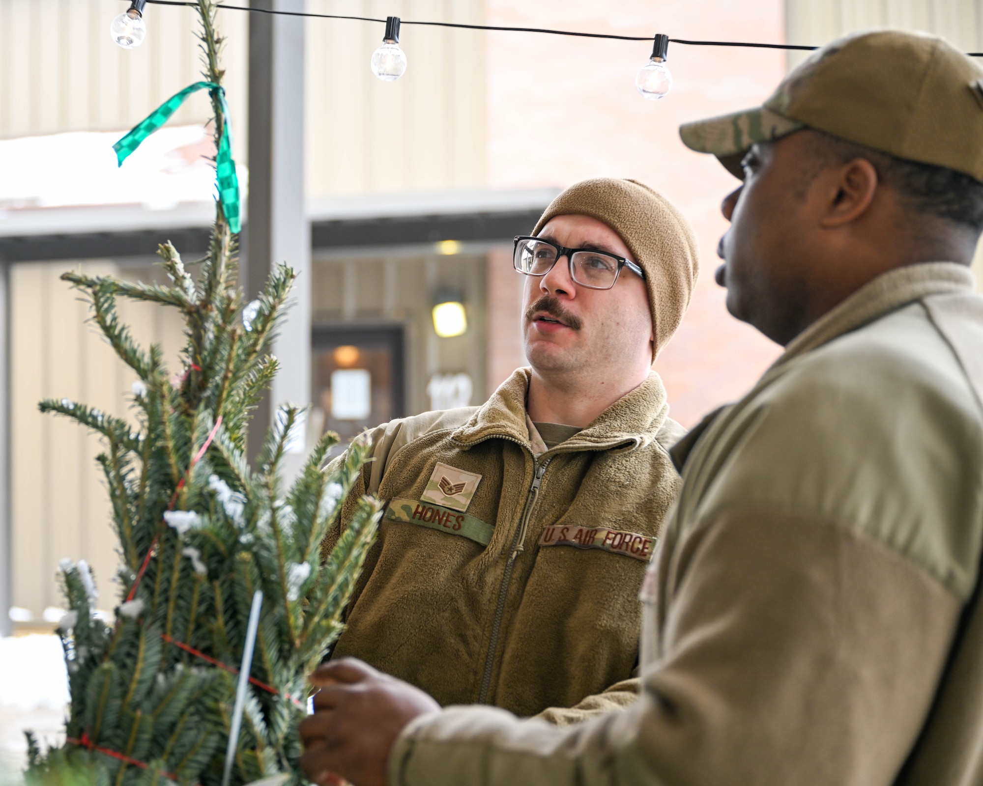 Staff Sgt. Brandon Hones and Senior Airman Ramel Thomas, fuels specialists with the 910th Logistics Readiness Squadron, pick out free Christmas trees, Dec. 7, 2024, at Youngstown Air Reserve Station, Ohio.