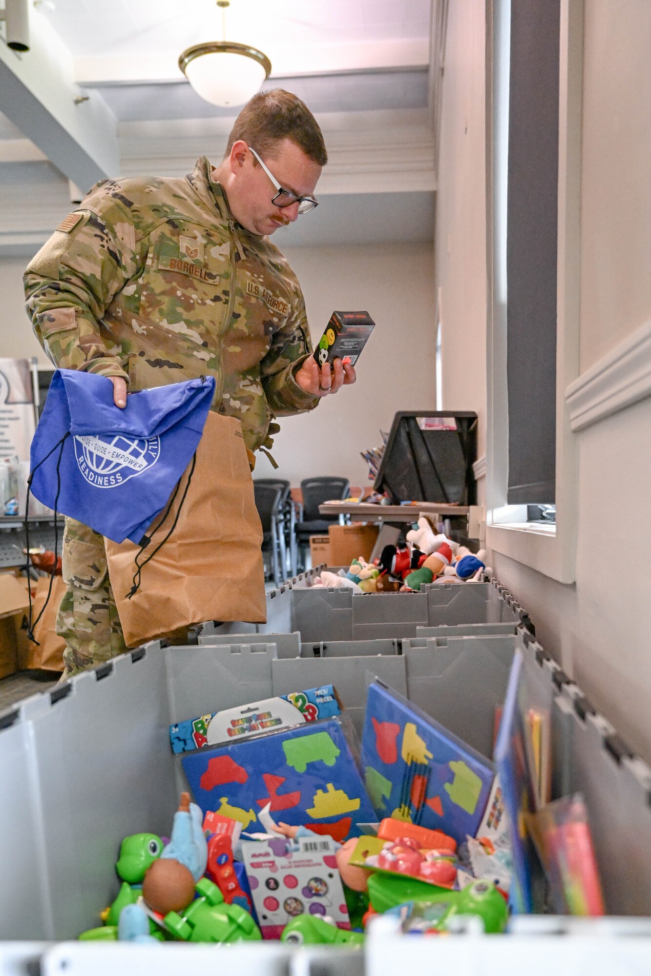 Tech. Sgt. John Bordell, an aircraft metals technician with the 910th Maintenance Squadron, picks out free toys, Dec. 7, 2024, at Youngstown Air Reserve Station, Ohio.