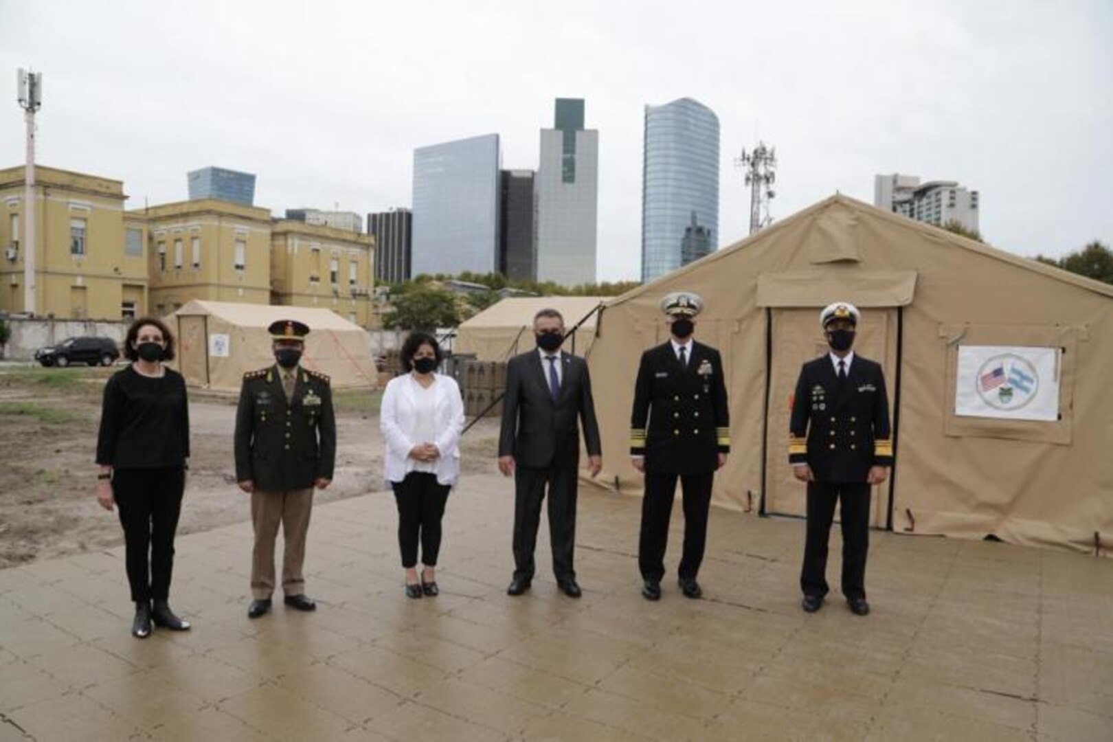 SOUTHCOM Commander Admiral Craig S. Faller stands in front of a field hospital with Argentinian leaders.