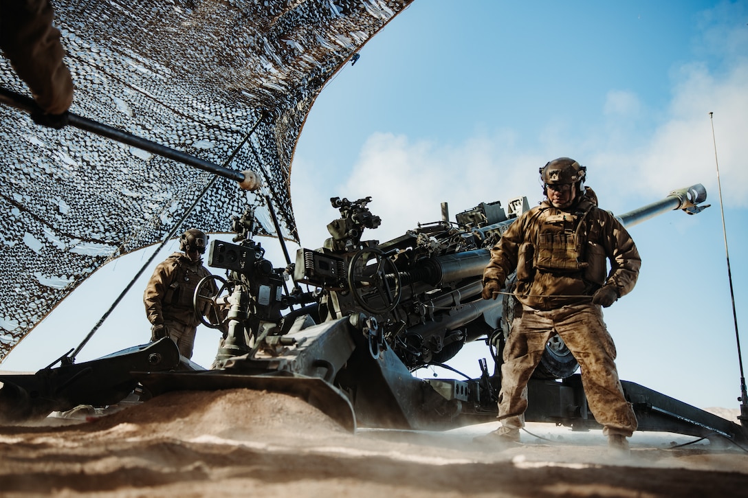 U.S. Marine Corps Cpl. John Estrada, pulls the firing handle on an M777 Howitzer during a Fire Support Coordination Exercise (FSCEX) in support of Service Level Training Exercise (SLTE) 0-25 in Twentynine Palms, California, Dec. 5, 2024.